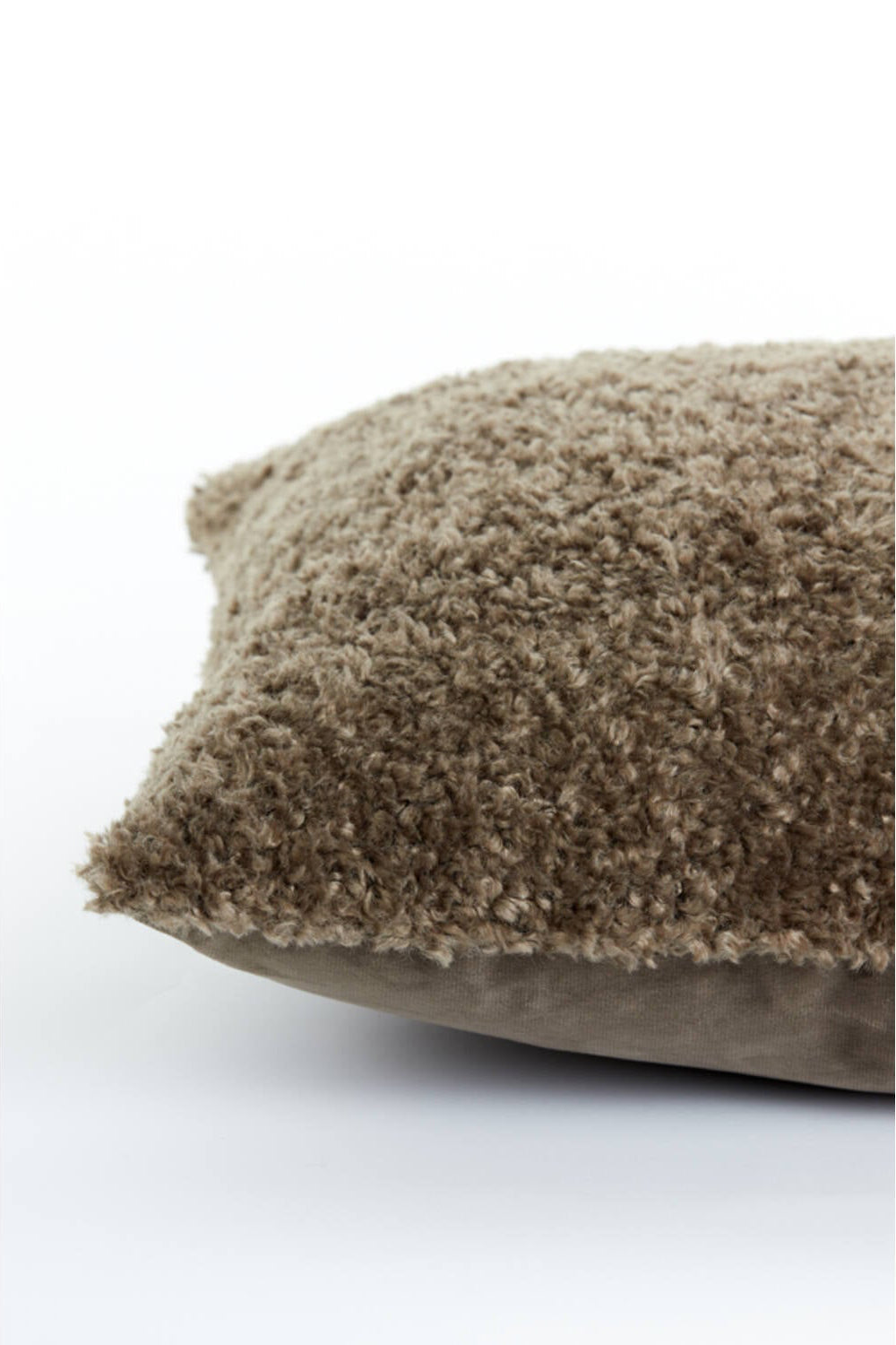 Detailfoto bruin fluffy sierkussen met zachte teddy structuur