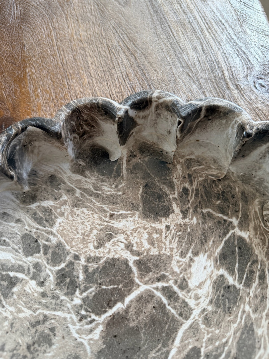 Detail van de bruine marmerlook en golvende rand van het decoratieplateau